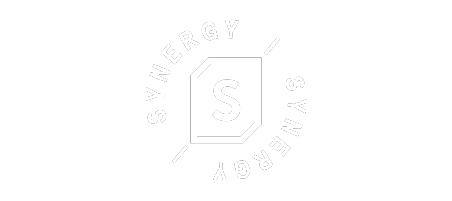 A black emblem with the word SYNERGY circling around a stylized letter S in the center, encased in a shield-like shape. The text is in white.